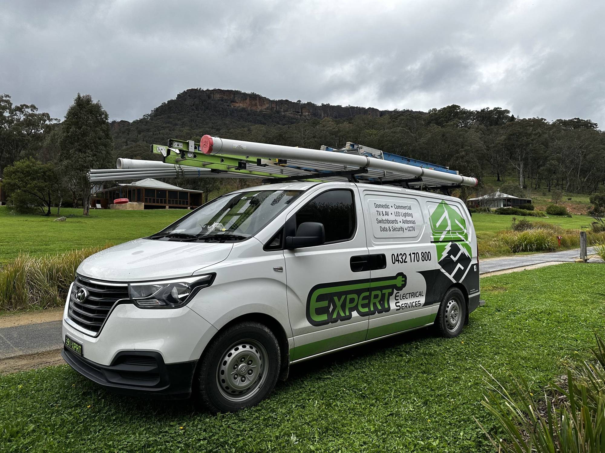 Expert Electrical Services van parked below the Blue Mountains escarpment