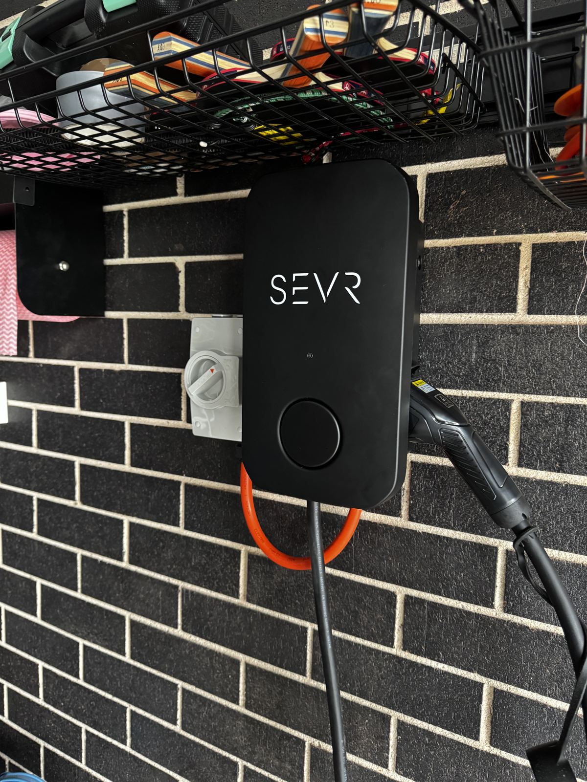 Home EV charger installed in a garage by Expert Electrical Services