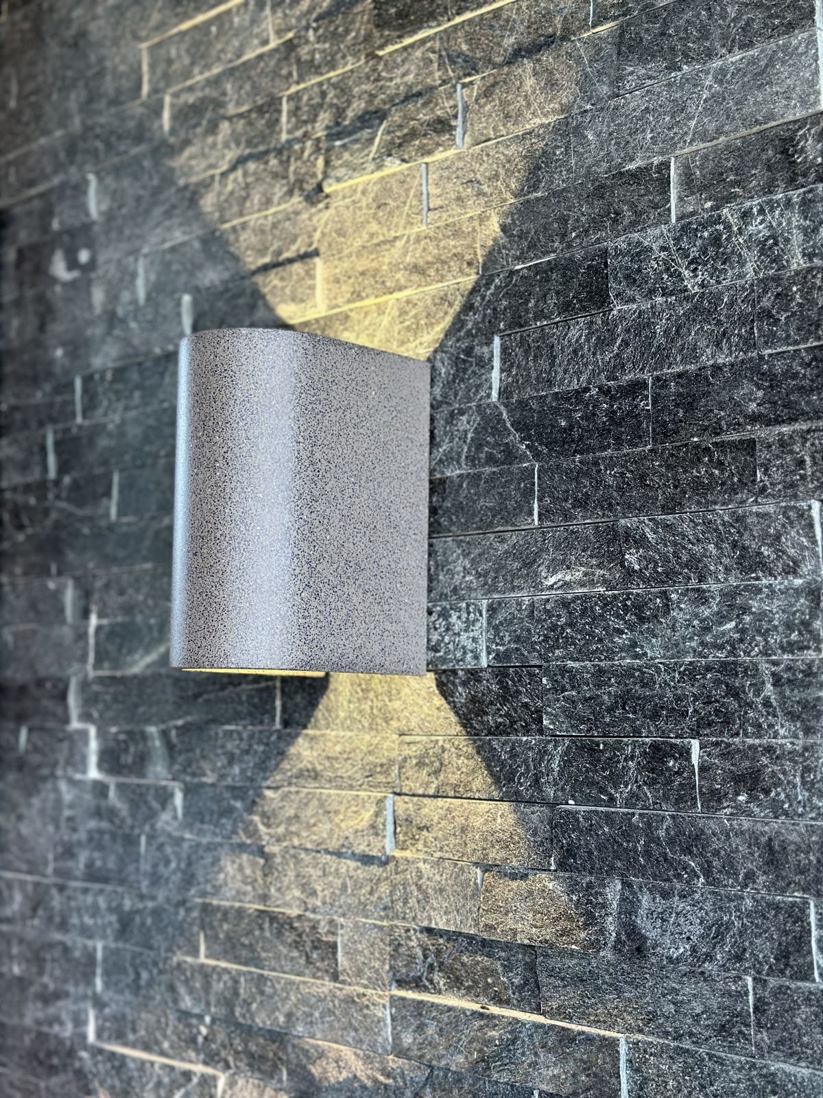Outdoor wall light installed on a stone feature wall