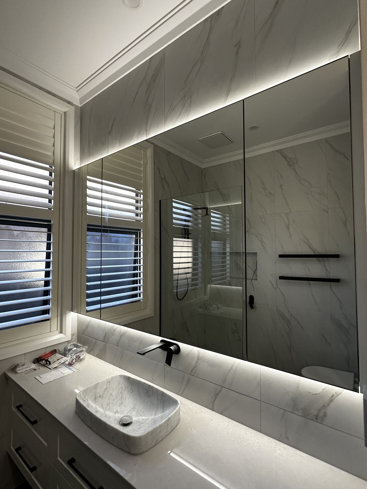 Bathroom with LED mirror and strip lighting installed by Expert Electrical Services