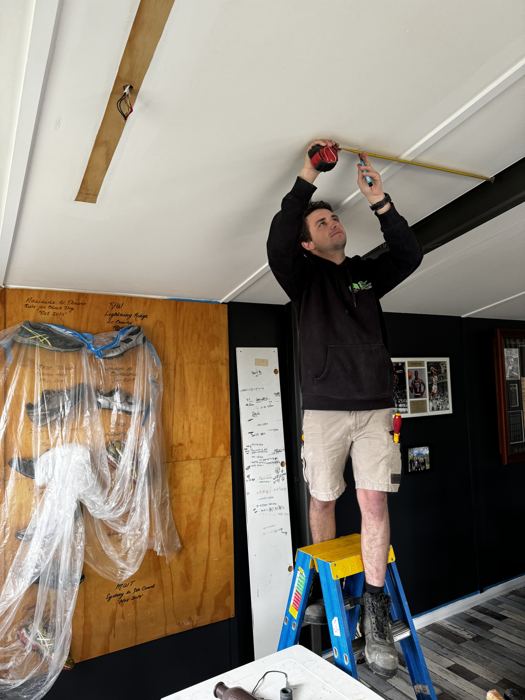 Electrician fitting a ceiling light