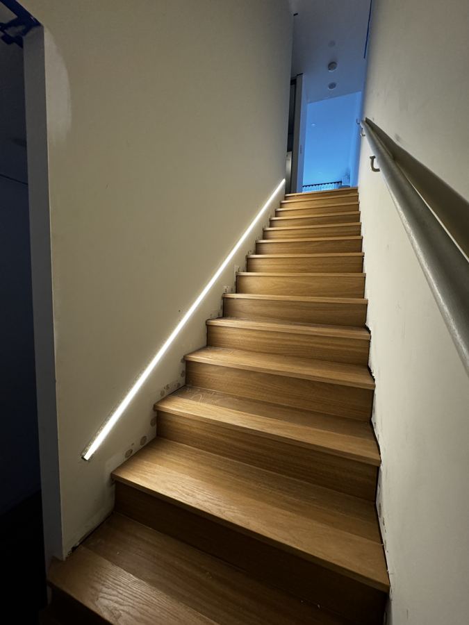Timber staircase with LED handrail lighting